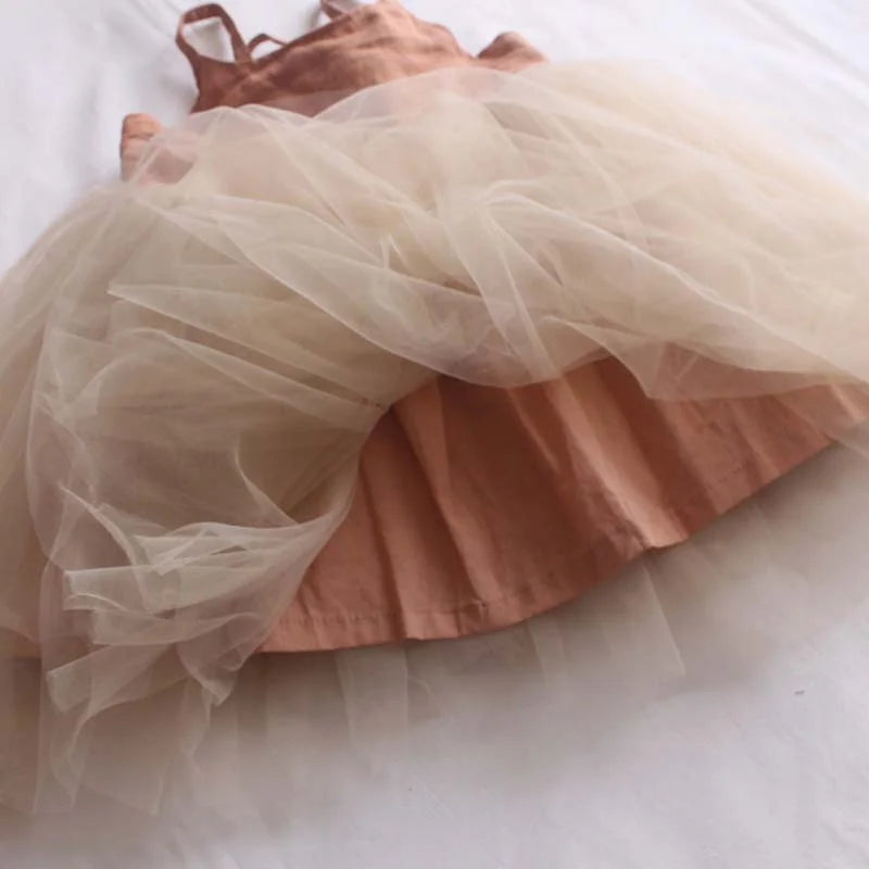 Pink dress with a sheer tulle skirt on a white background