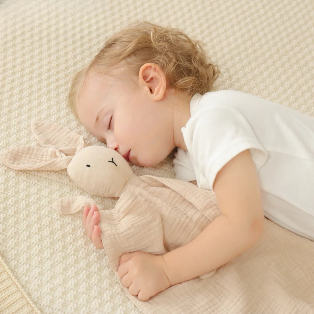 baby sleeping with bunny lovey