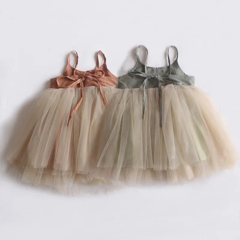 Two children's tutu skirts with ribbons on a white background